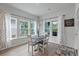 Bright dining area with natural light, white table and chairs, and scenic views from the surrounding windows at 1384 Locals St, Summerville, SC 29485