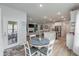 Cozy dining area with round table and white chairs, seamlessly connecting to the kitchen and living room at 1384 Locals St, Summerville, SC 29485