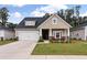 Charming single-Gathering home with a two-car garage, inviting front porch, and manicured lawn at 1384 Locals St, Summerville, SC 29485