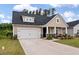 Charming single-Gathering home with a two-car garage, inviting front porch, and manicured lawn at 1384 Locals St, Summerville, SC 29485