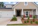 Charming single-Gathering home with a two-car garage, inviting front porch, and manicured lawn at 1384 Locals St, Summerville, SC 29485