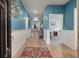 Inviting hallway with wainscoting, stylish decor, and wood-look floors leading to various rooms at 1384 Locals St, Summerville, SC 29485