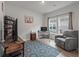 Comfortable home office with a desk, gray recliner, and a large area rug at 1384 Locals St, Summerville, SC 29485