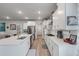 Modern kitchen featuring white cabinets, stainless steel appliances, light wood floors, and a center island at 1384 Locals St, Summerville, SC 29485