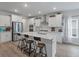 Bright, modern kitchen with white cabinets, stainless steel appliances, and a large quartz island with seating at 1384 Locals St, Summerville, SC 29485