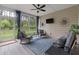 Relaxing screened porch with comfortable seating, ceiling fan, and wooded views at 1384 Locals St, Summerville, SC 29485
