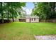 Large, grassy backyard featuring a brick and tan siding home at 14 Aldene Ave, Goose Creek, SC 29445