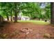 Expansive backyard with mature trees, a fire pit, and a detached structure, ideal for outdoor living at 14 Aldene Ave, Goose Creek, SC 29445