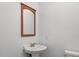 Powder room featuring a wooden-framed mirror and pedestal sink at 14 Aldene Ave, Goose Creek, SC 29445