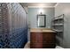 Bathroom featuring a shower with a patterned curtain, a dark vanity, and a shelf at 14 Aldene Ave, Goose Creek, SC 29445