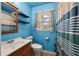 Bathroom featuring a window, patterned shower curtain and blue walls at 14 Aldene Ave, Goose Creek, SC 29445