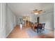 Open-concept dining area with hardwood floors, ceiling fan, flowing into a kitchen with counter seating at 14 Aldene Ave, Goose Creek, SC 29445