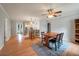 Open-concept dining area with hardwood floors, ceiling fan, leading into a kitchen with counter seating at 14 Aldene Ave, Goose Creek, SC 29445