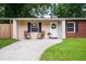 Inviting front porch with seating, a charming wreath on the door, and well-manicured lawn enhance the curb appeal at 14 Aldene Ave, Goose Creek, SC 29445