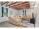 Bright living room with exposed wood beams, a large comfortable sectional, and blue accent rug at 14 Aldene Ave, Goose Creek, SC 29445