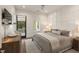 Comfortable bedroom with grid accent wall, ceiling fan, and access to balcony at 1405 Mataoka St, Mount Pleasant, SC 29464