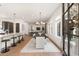 Open-concept dining area with modern chandelier, hardwood floors and large windows allowing for ample natural light at 1405 Mataoka St, Mount Pleasant, SC 29464