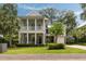 Charming two-story home with a double porch, lush landscaping, and a well-manicured lawn at 1405 Mataoka St, Mount Pleasant, SC 29464