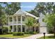 Charming two-story home with a welcoming front porch, manicured lawn and beautiful landscaping at 1405 Mataoka St, Mount Pleasant, SC 29464