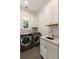 Modern laundry room featuring stainless steel washer and dryer and white cabinets at 1405 Mataoka St, Mount Pleasant, SC 29464