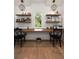 Bright office space with a shared desk under a window and decorative shelving at 1405 Mataoka St, Mount Pleasant, SC 29464