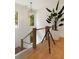 Bright staircase featuring modern railing, wood treads, and a statement light fixture at 1405 Mataoka St, Mount Pleasant, SC 29464