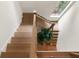 Stylish staircase with wooden steps, stainless steel railing, and skylight at 1405 Mataoka St, Mount Pleasant, SC 29464