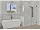 Luxurious bathroom with a soaking tub, glass-enclosed shower, and a large window with natural light at 142 Argosy Dr, Summerville, SC 29483