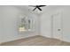Bright bedroom featuring light hardwood floors, a ceiling fan, and a window with views of the outdoors at 142 Argosy Dr, Summerville, SC 29483