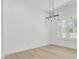 Empty dining room with modern lighting fixture and sun-filled windows, creating a light ambiance at 142 Argosy Dr, Summerville, SC 29483