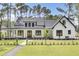 Beautiful modern farmhouse exterior with a lush green lawn and inviting front porch at 142 Argosy Dr, Summerville, SC 29483