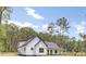 Beautiful modern farmhouse with an inviting covered porch surrounded by lush greenery at 142 Argosy Dr, Summerville, SC 29483