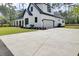 Exterior view of modern farmhouse with a large driveway and attached garage at 142 Argosy Dr, Summerville, SC 29483