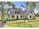 Charming home featuring a well-manicured lawn, dark trim, and classic farmhouse architectural details at 142 Argosy Dr, Summerville, SC 29483
