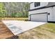 Exterior shows a white garage door with a concrete driveway leading to a modern farmhouse-style home at 142 Argosy Dr, Summerville, SC 29483