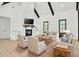 Cozy living room featuring a brick fireplace, comfortable seating, and bright natural light at 142 Argosy Dr, Summerville, SC 29483