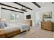 Cozy main bedroom with wood flooring, wooden beams, and natural light from the large window at 142 Argosy Dr, Summerville, SC 29483