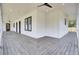 Covered porch with grey stained wood flooring and black framed windows and doors at 142 Argosy Dr, Summerville, SC 29483