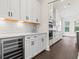 Spacious kitchen with white cabinetry, stainless steel wine cooler, and elegant countertops at 1427 Dahlia Rd, Mount Pleasant, SC 29464