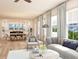 Bright open-concept living room flows to dining area, featuring neutral tones and an abundance of natural light at 1427 Dahlia Rd, Mount Pleasant, SC 29464