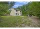 Large backyard with green spaces, mature trees, a cozy fire pit area, and a patio at 1506 Southwick Dr, Johns Island, SC 29455