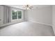 Bedroom featuring carpet floor, ceiling fan and a large window with a view of trees at 1506 Southwick Dr, Johns Island, SC 29455