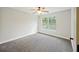 Cozy bedroom with a ceiling fan, large window offering natural light, and plush carpeting at 1506 Southwick Dr, Johns Island, SC 29455