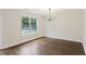 Dining area featuring hardwood floors, modern chandelier, and a window with a view of the backyard at 1506 Southwick Dr, Johns Island, SC 29455