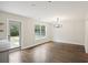 Dining area featuring hardwood floors, modern chandelier, and easy access to the backyard at 1506 Southwick Dr, Johns Island, SC 29455