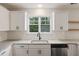 Kitchen sink with granite countertop, stainless dishwasher, white cabinets, and natural light from window at 1506 Southwick Dr, Johns Island, SC 29455