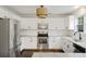 Modern kitchen featuring stainless steel appliances, white cabinetry, and granite countertops at 1506 Southwick Dr, Johns Island, SC 29455