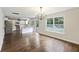 Spacious living space featuring hardwood floors, modern chandelier, and easy access to the kitchen and backyard at 1506 Southwick Dr, Johns Island, SC 29455