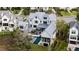 Aerial view of a white home with a backyard pool, blending modern architecture with natural surroundings at 156 Nobels Point St, Charleston, SC 29492