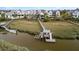 Aerial view of waterfront home with private dock, offering direct access to the water at 156 Nobels Point St, Charleston, SC 29492